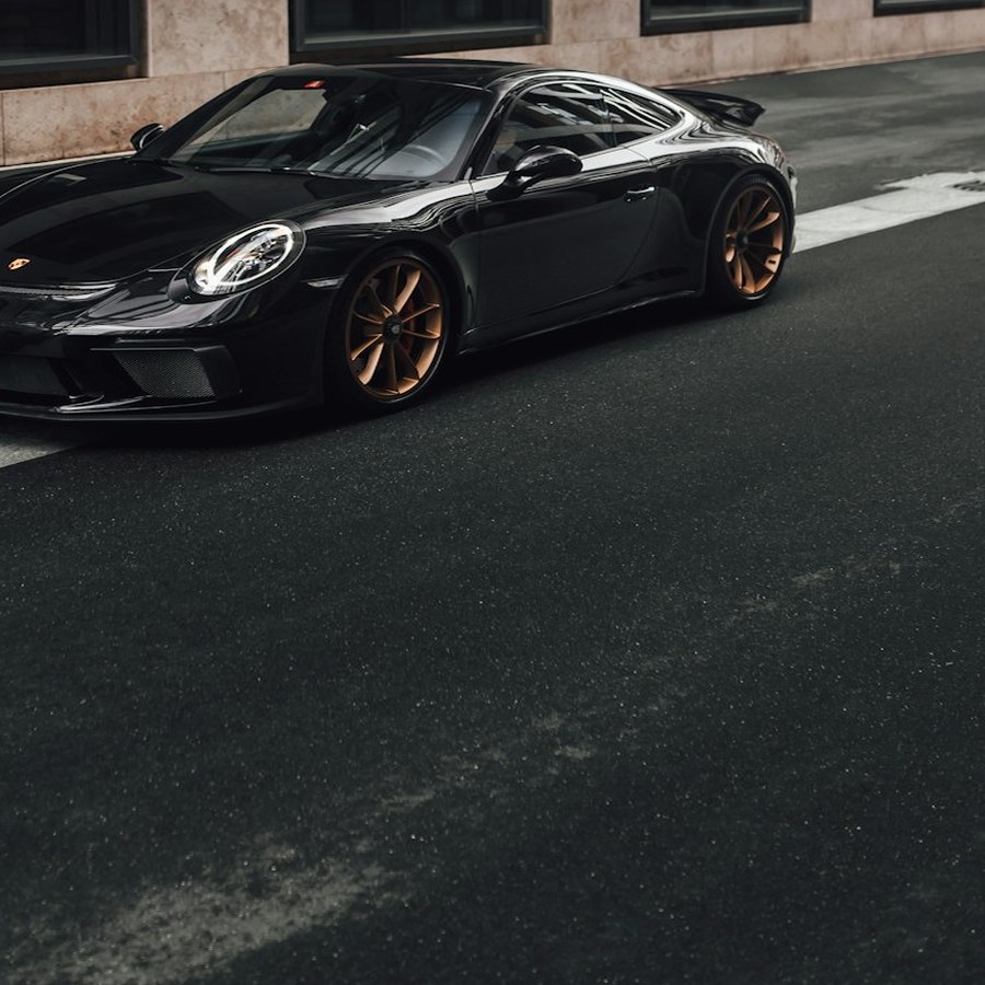 Black sports car with fully restored alloy wheels